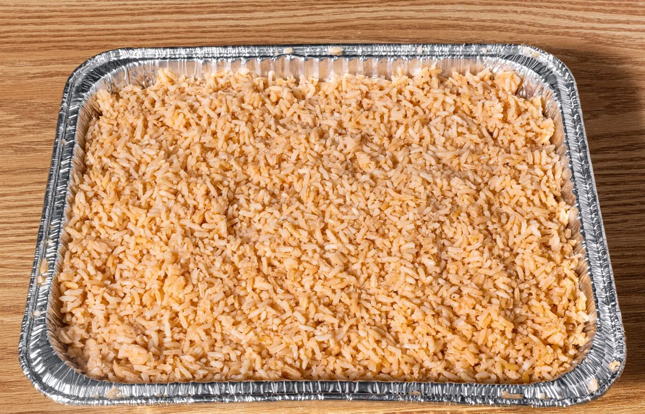 Large tray of Mexican rice, ready for catering service